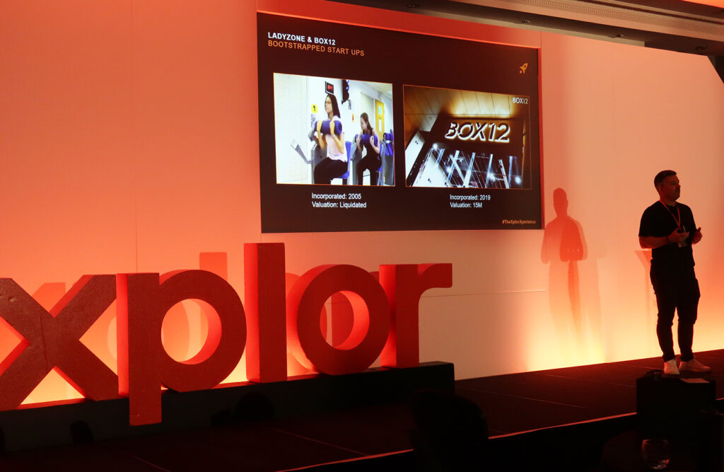 A photo of Jamie Cartwright, Co-Founder of BOX12 and SAS Who Dares Wins participant, on stage at the Xplor Xperience in May 2024 at The Park Royal Hotel in Cheshire, UK.