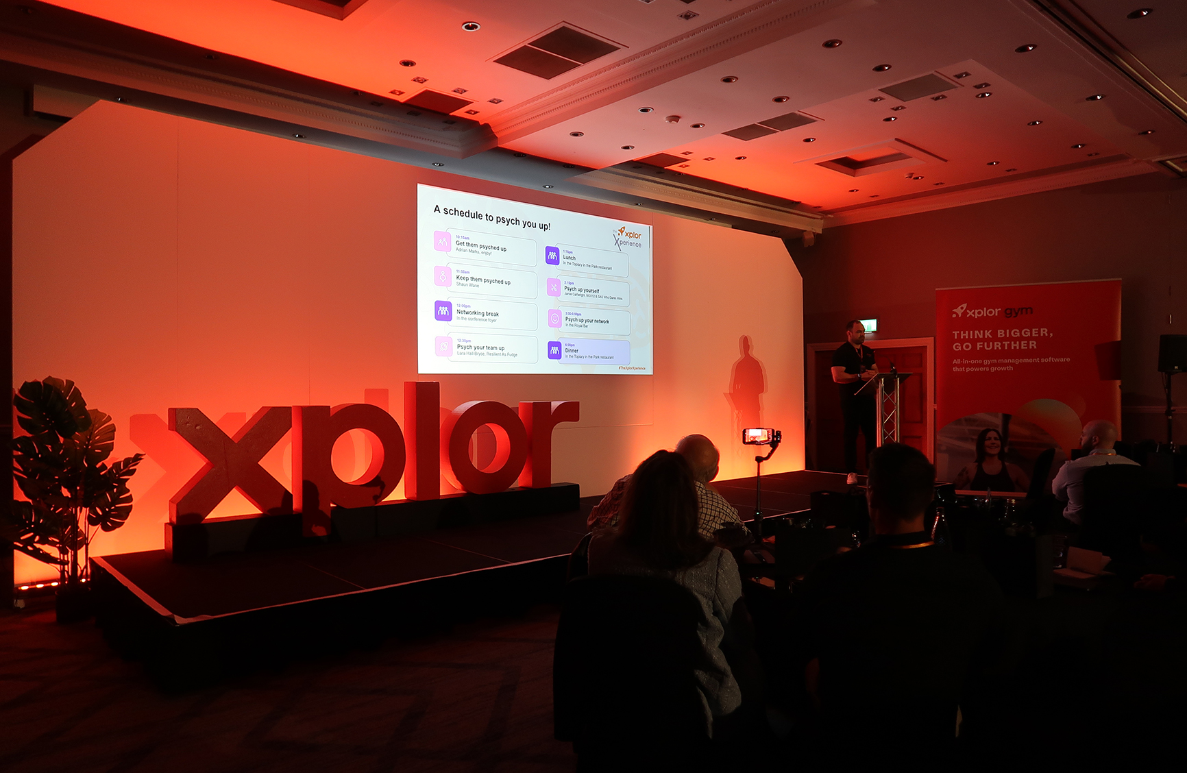 A photo of Dave Alstead, Commercial Director at Xplor Gym, on stage at the Xplor Xperience in May 2024.