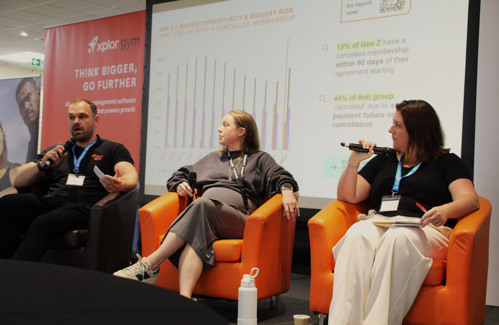 A photo from the Independent Gyms Summer Conference showing Dave Alstead, Georgie Poole, and Julie Allen discussing new gym membership sales research findings on Gen Z.